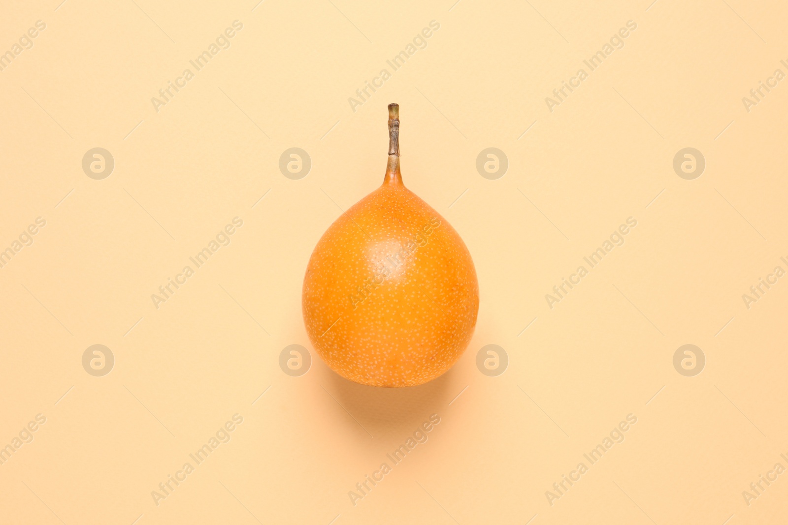 Photo of Delicious ripe granadilla on beige background. top view