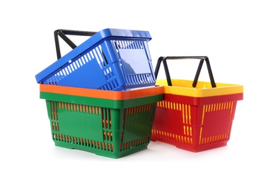 Colorful plastic shopping baskets on white background