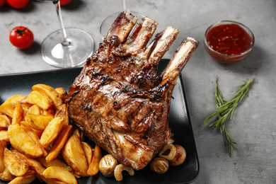 Delicious grilled ribs served on light grey table