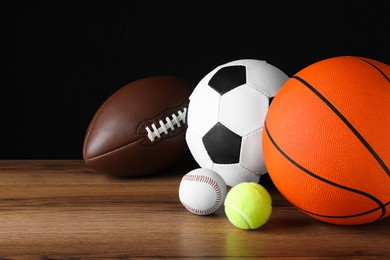Photo of Set of different sport balls on wooden surface
