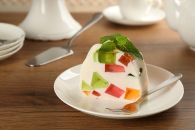 Photo of Delicious broken glass jelly dessert on wooden table