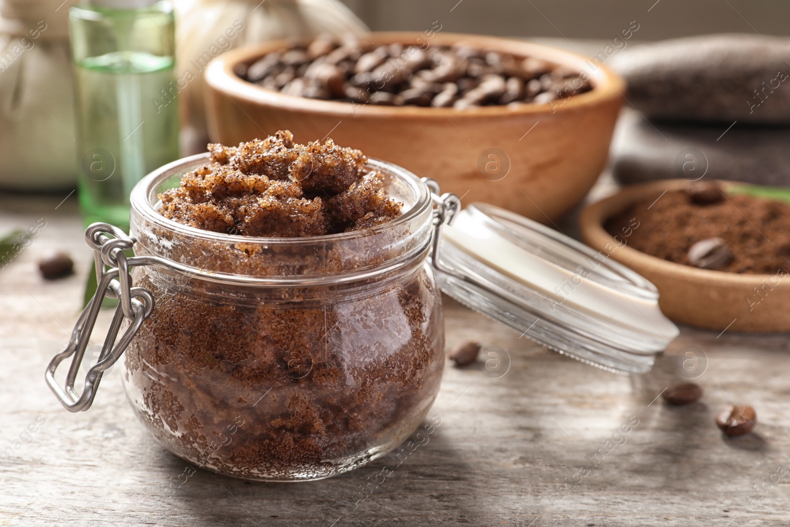 Photo of Jar with handmade natural body scrub on wooden table