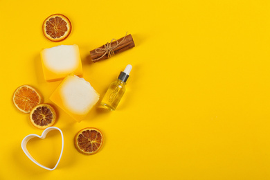Photo of Flat lay composition with natural handmade soap and ingredients on yellow background. Space for text