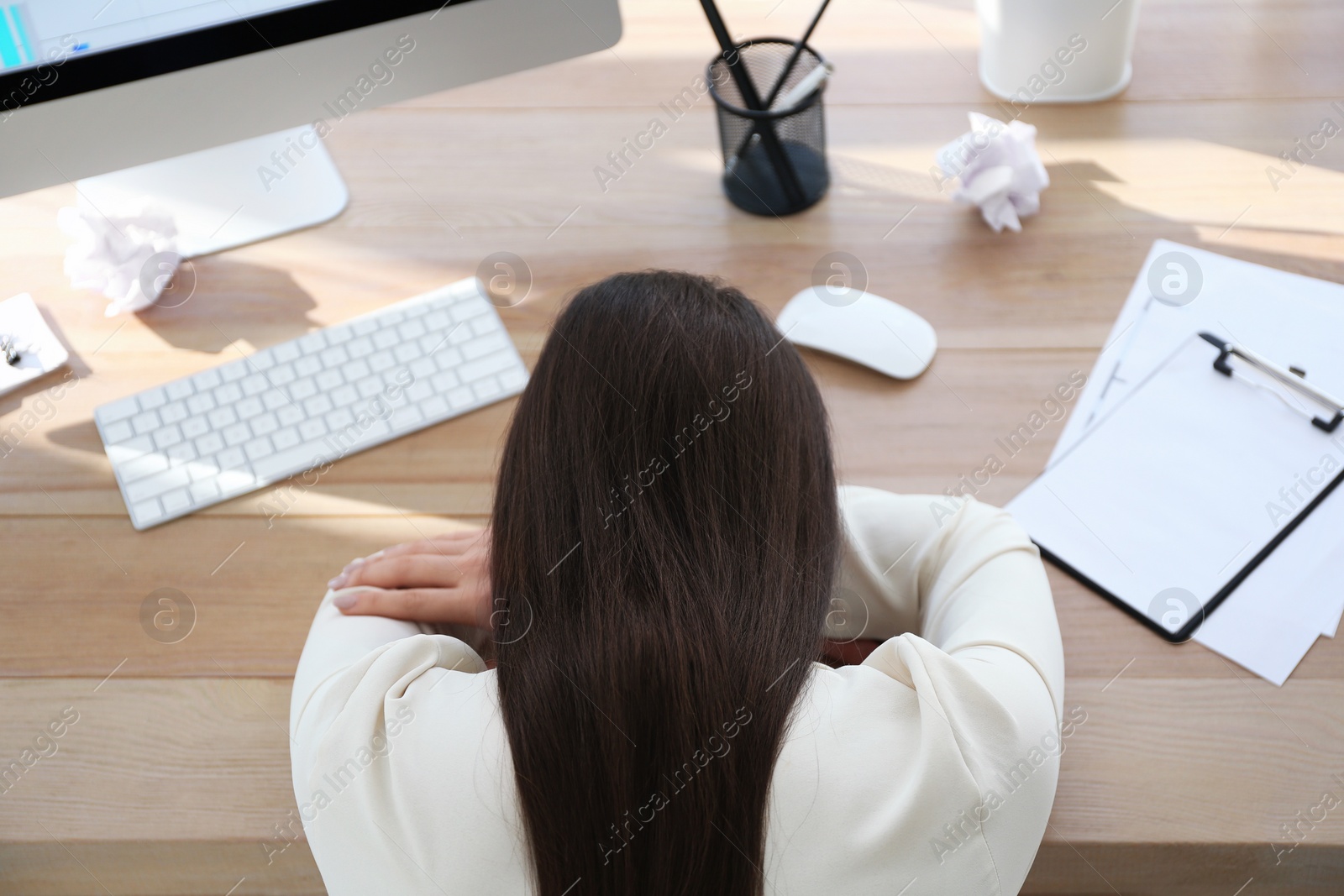 Photo of Stressed out businesswoman at workplace in office, above view