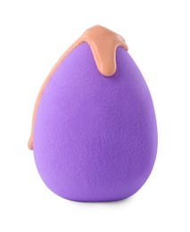 Purple makeup sponge with skin foundation isolated on white