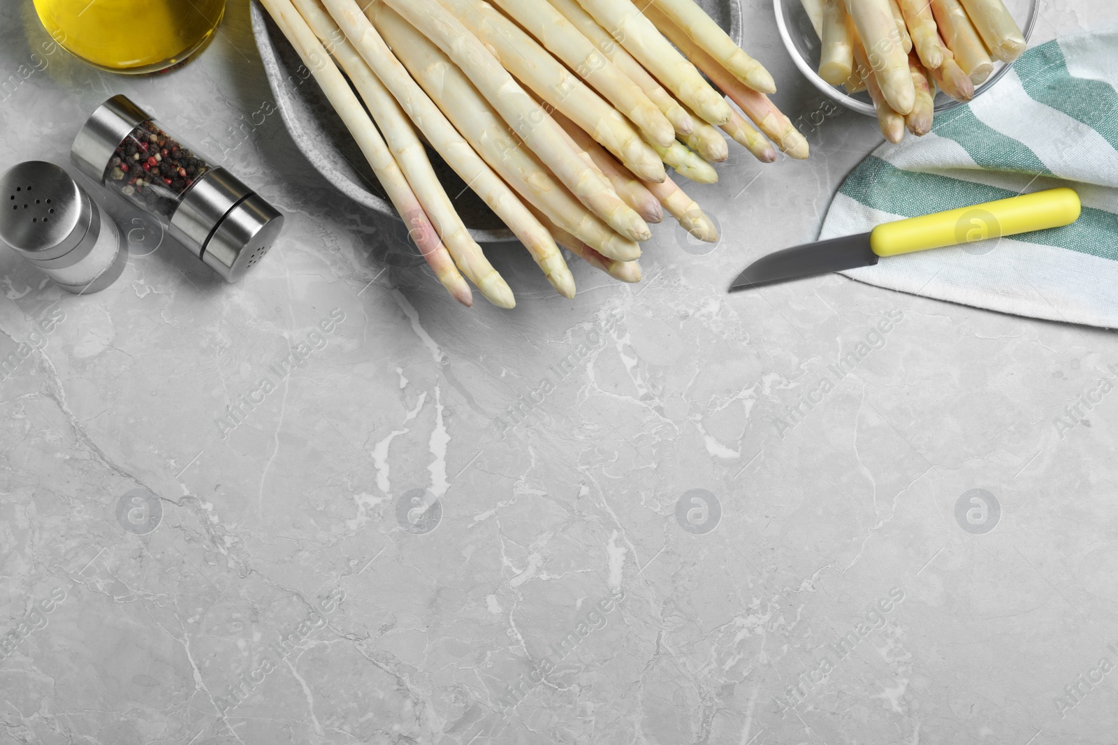 Photo of Flat lay composition with white asparagus on grey marble table. Space for text