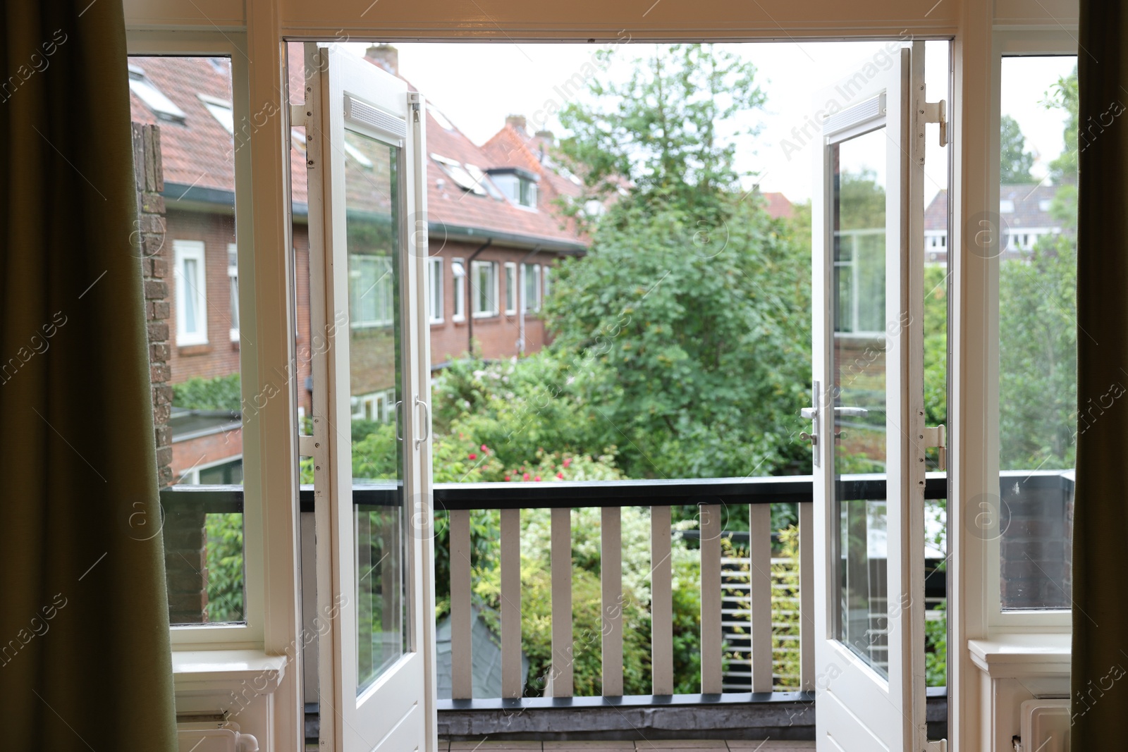 Photo of Beautiful view on balcony and inner yard with green trees from apartment