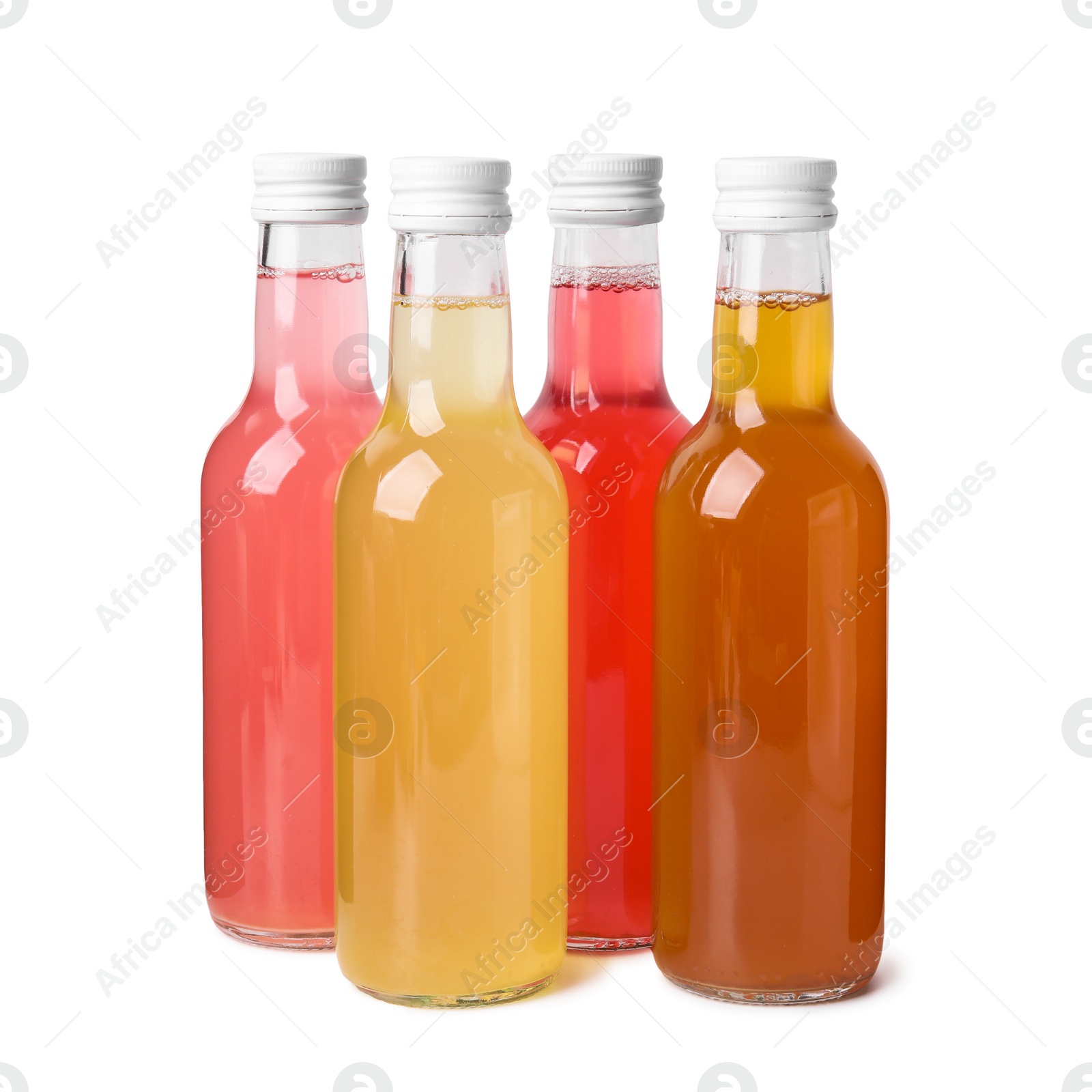 Photo of Delicious kombucha in glass bottles isolated on white