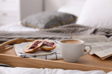 Photo of Morning coffee and sandwiches on tray in bedroom. Space for text