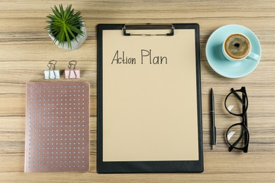 Photo of Flat lay composition of clipboard with action plan on wooden table