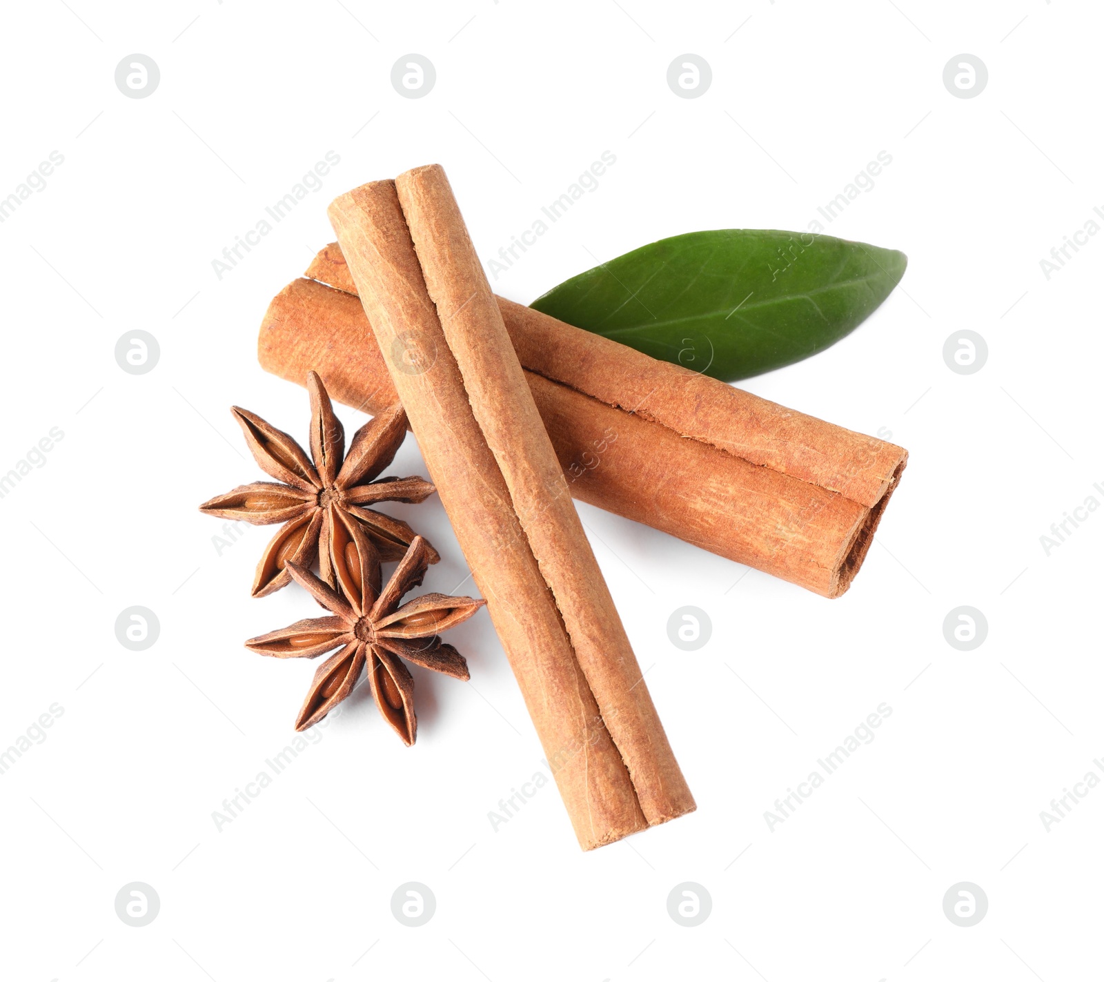 Photo of Cinnamon sticks, anise stars and green leaf isolated on white, above view