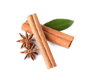 Photo of Cinnamon sticks, anise stars and green leaf isolated on white, above view