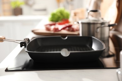 Frying pan with cooking oil on cooktop in kitchen