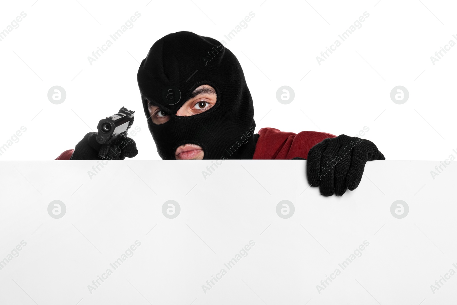 Photo of Thief in balaclava with gun on white background