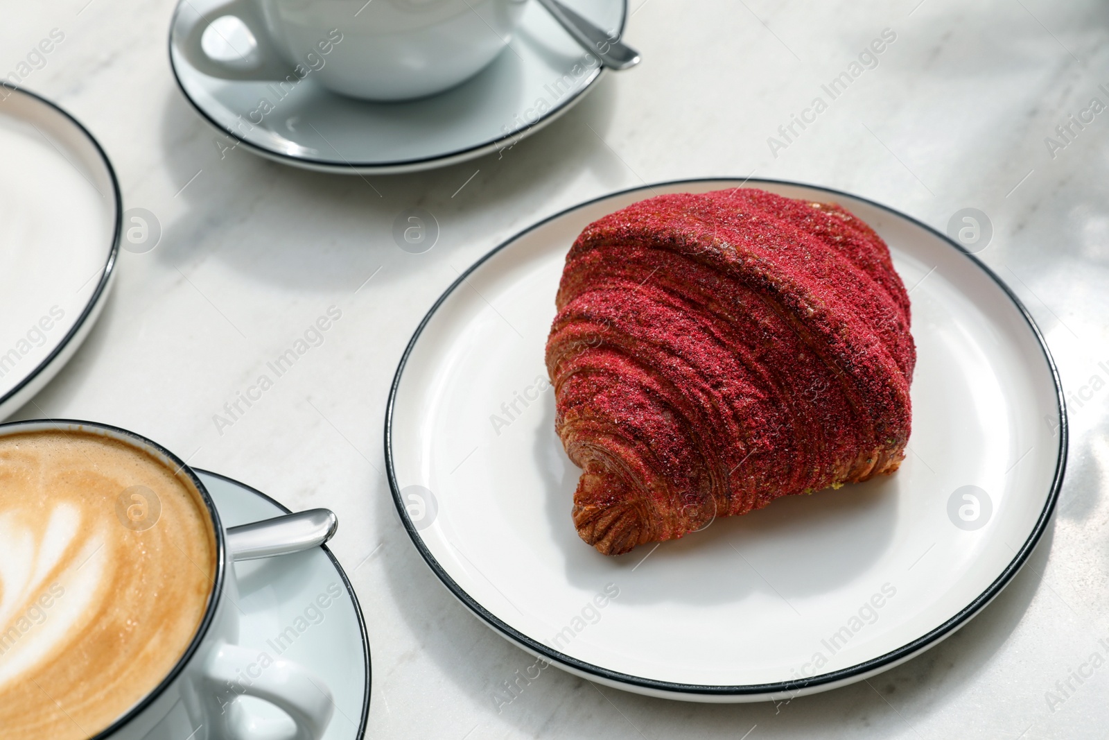 Photo of Delicious croissant and coffee on white marble table