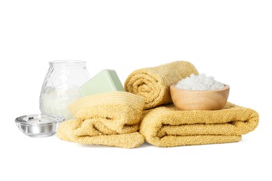 Photo of Spa composition. Towels, burning candles, sea salt and soap on white background