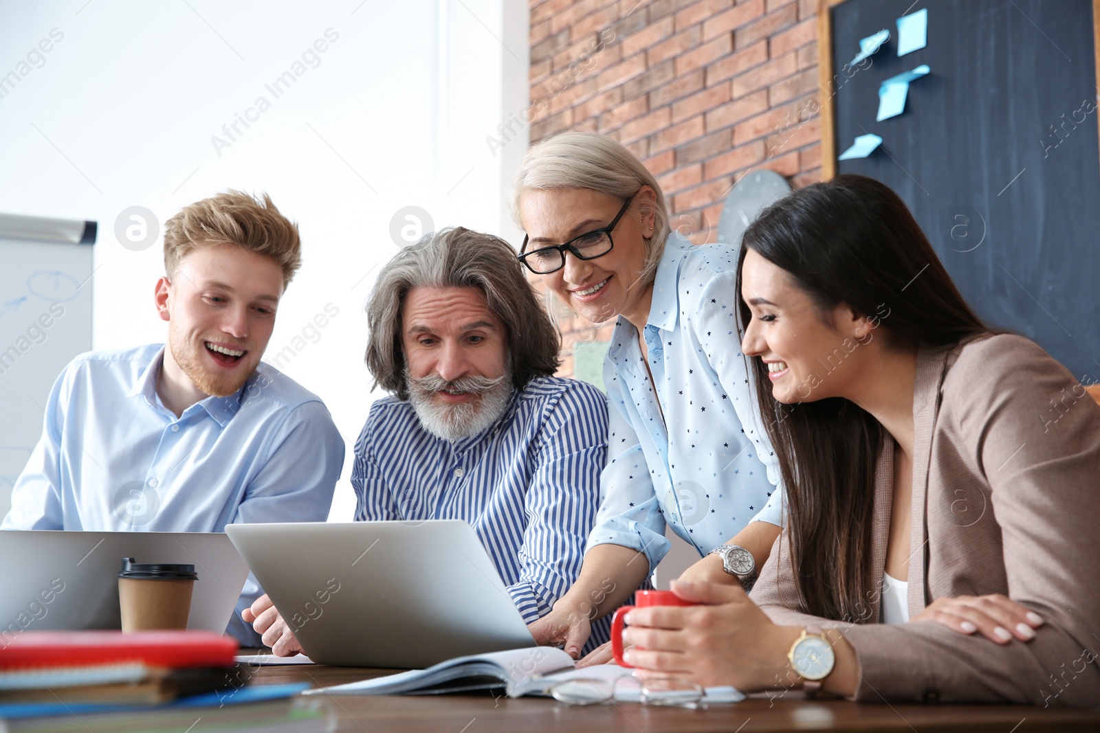 Photo of Business people discussing work matters at table in office. Professional communication