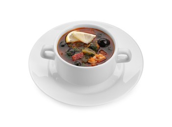 Photo of Meat solyanka soup with sausages, olives and vegetables in bowl isolated on white