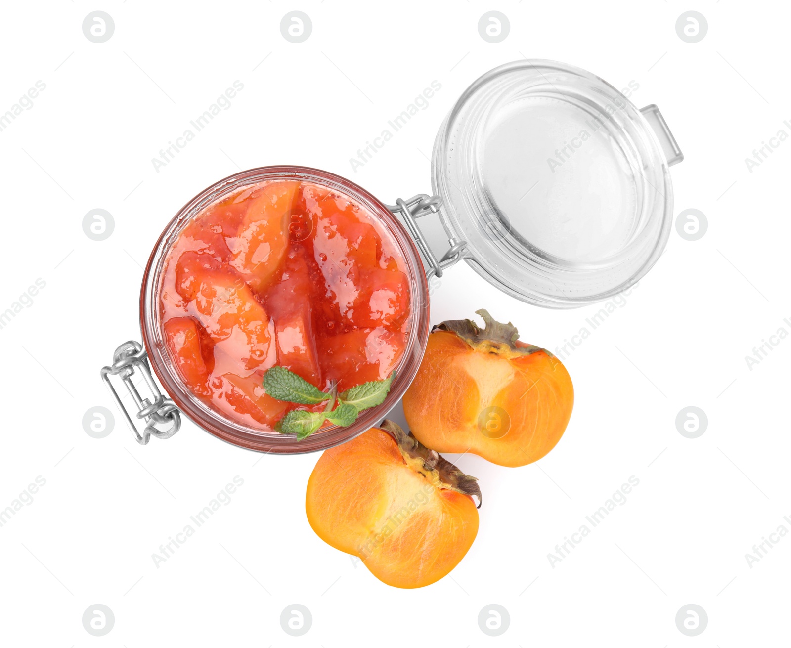 Photo of Jar of tasty persimmon jam and fresh fruits on white background, top view