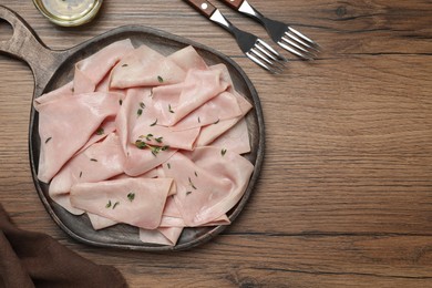 Photo of Delicious ham slices with thyme served on wooden table, flat lay. Space for text