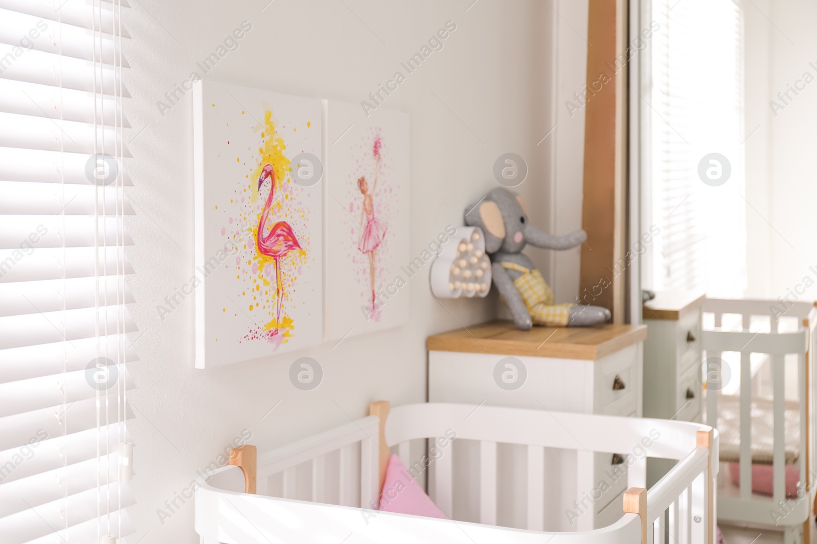 Photo of Baby room interior with beautiful pictures on wall