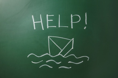Photo of Drawing of sinking boat and word "Help" on green chalkboard