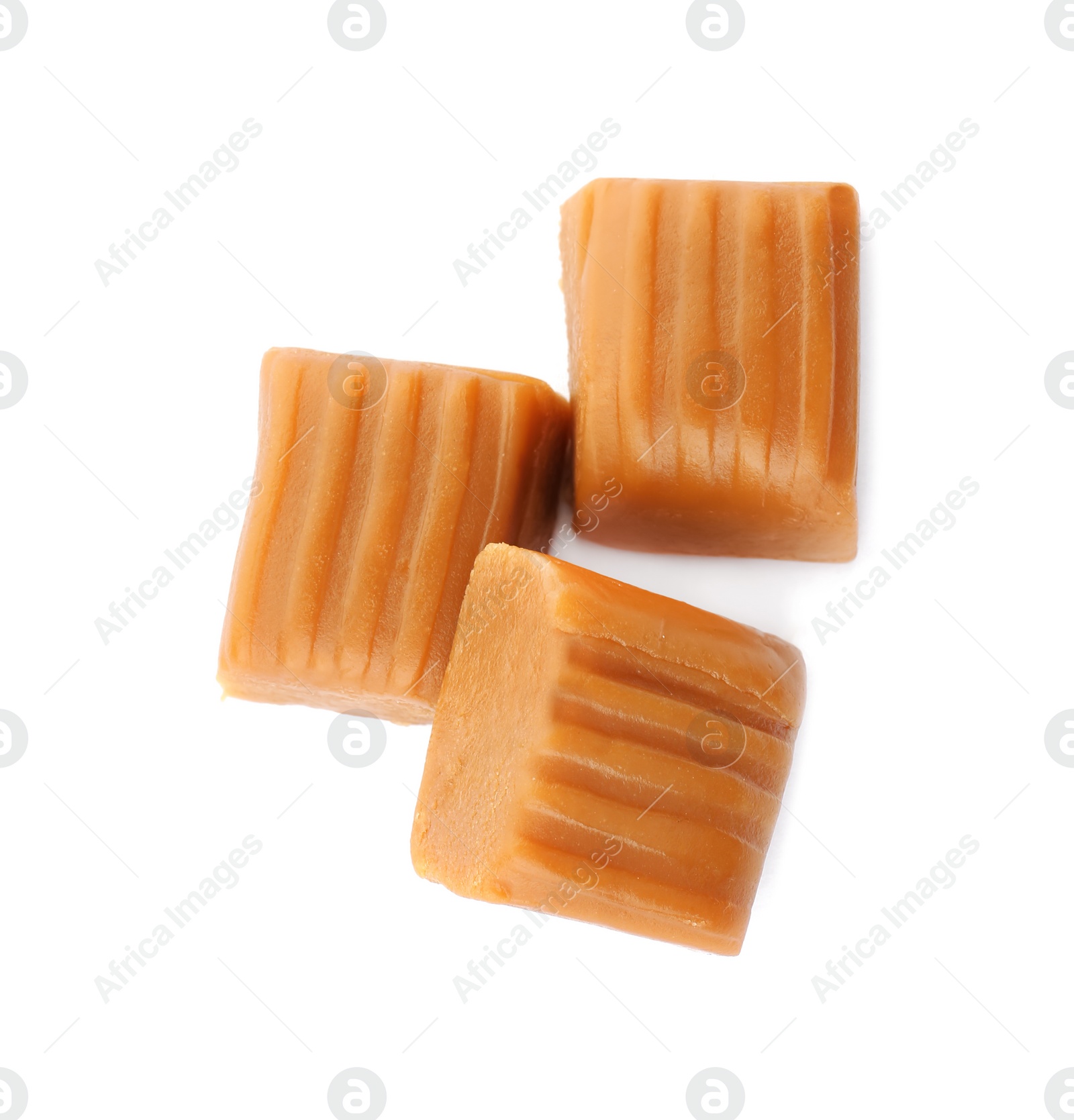 Photo of Delicious caramel candies on white background