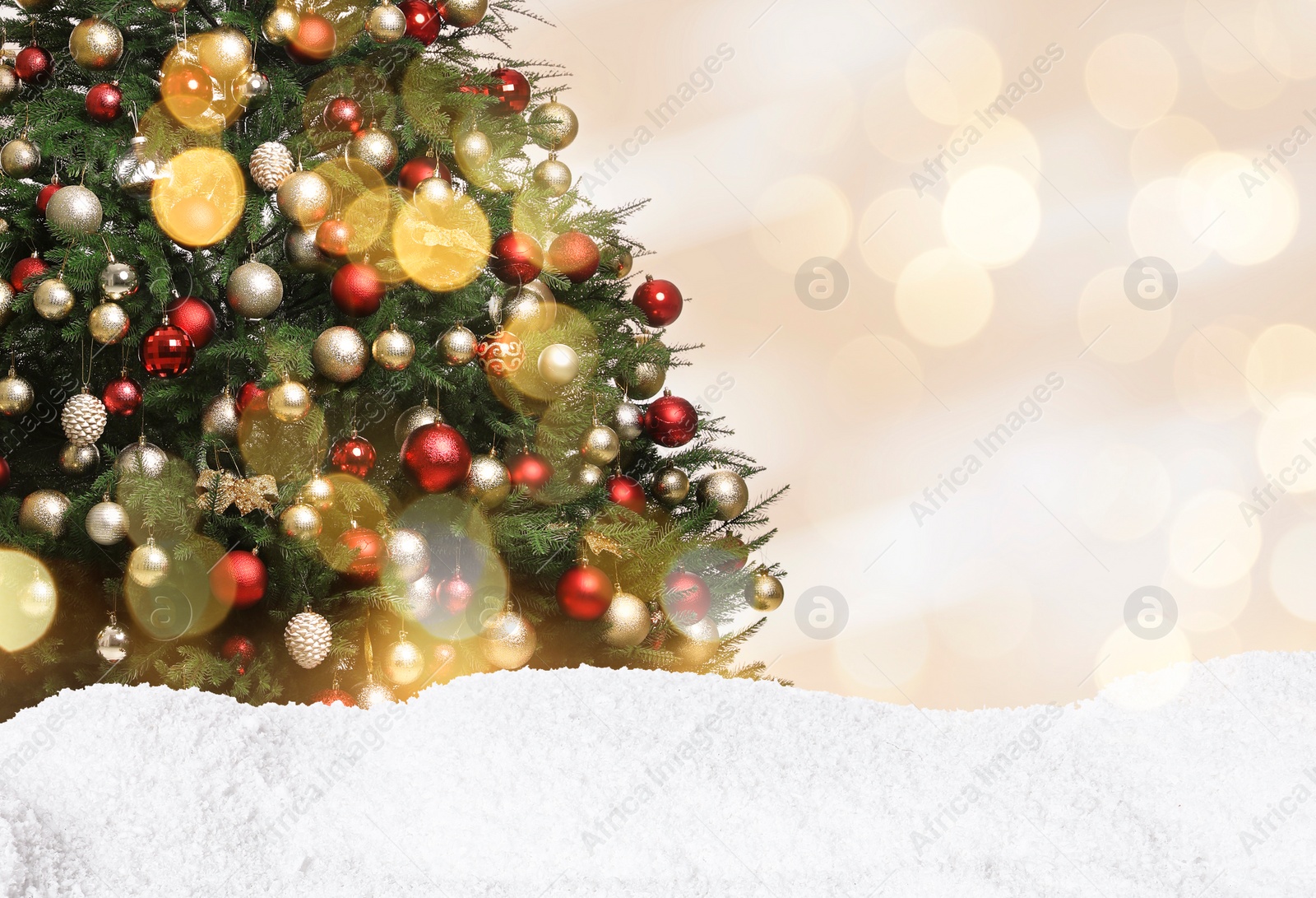 Image of Beautifully decorated Christmas tree and snow on light background, space for text. Bokeh effect