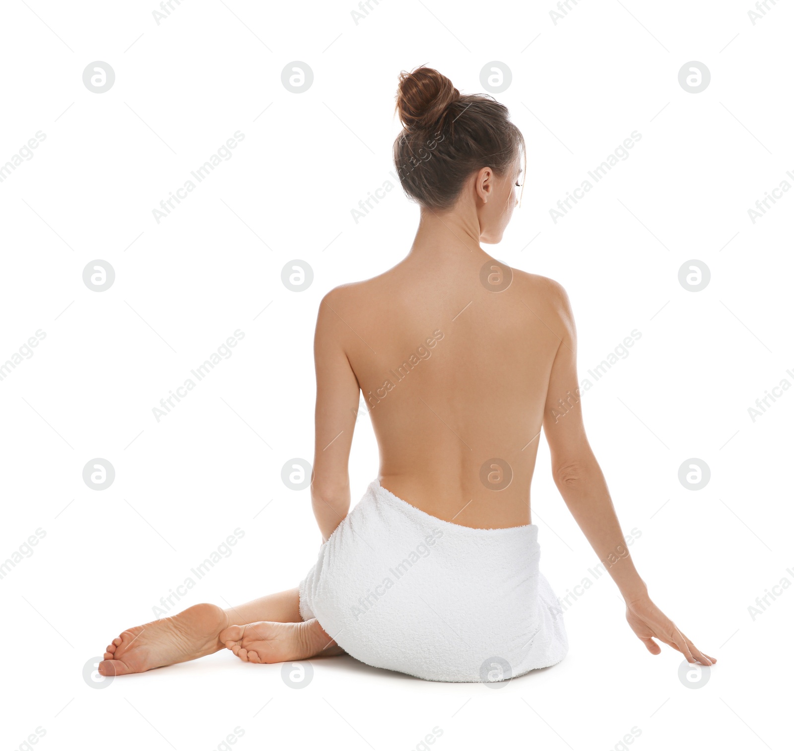 Photo of Back view of woman with perfect smooth skin sitting on white background. Beauty and body care