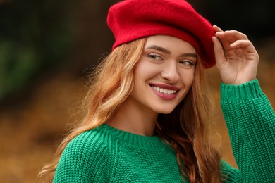 Portrait of smiling woman wearing autumn sweater outdoors