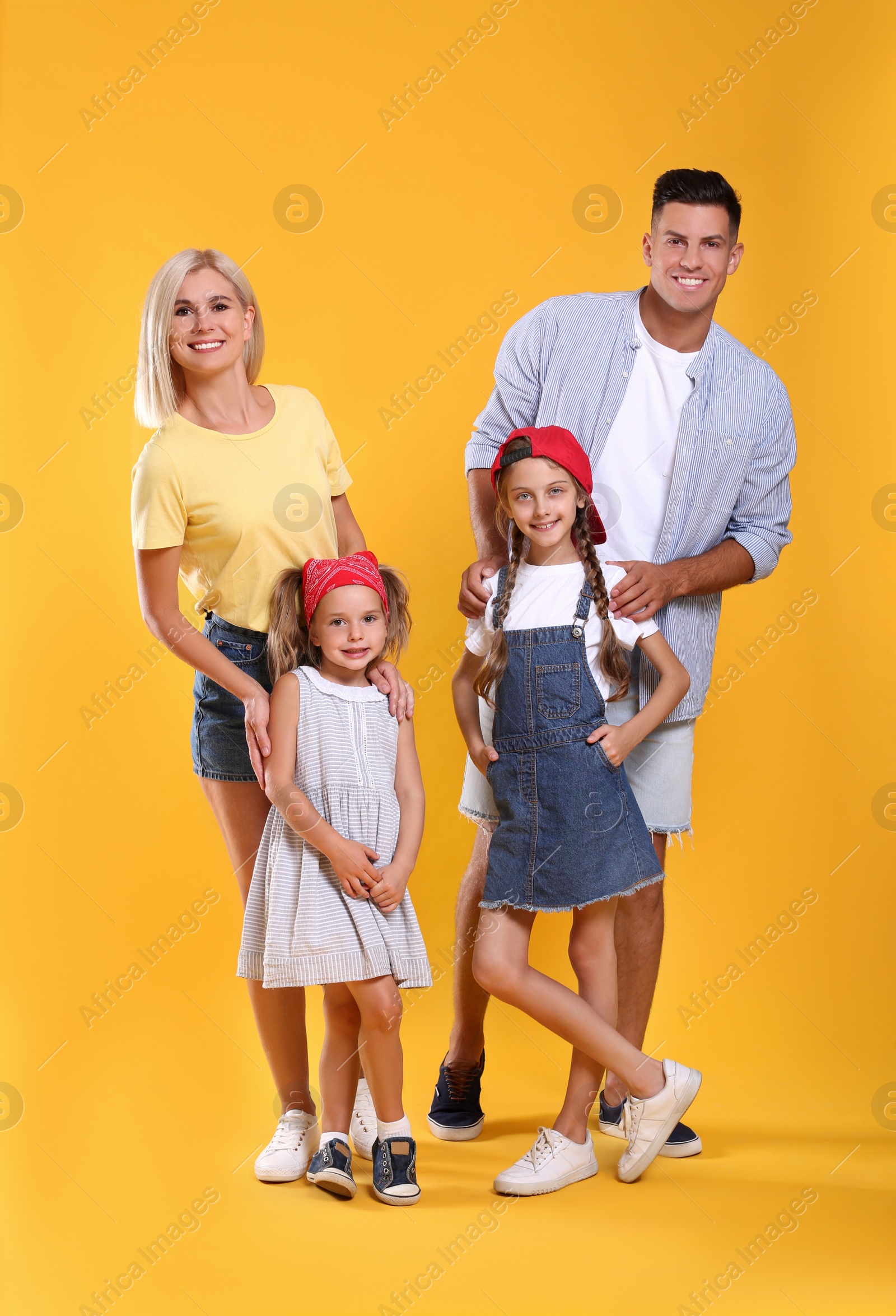 Photo of Portrait of happy family on yellow background