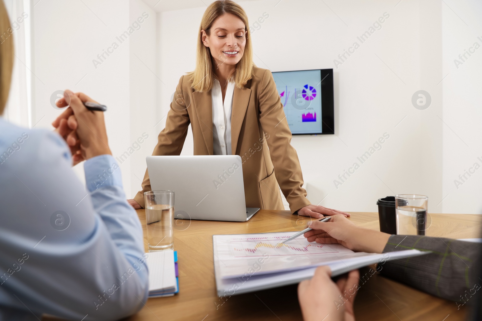 Photo of Businesswoman having meeting with her employees in office