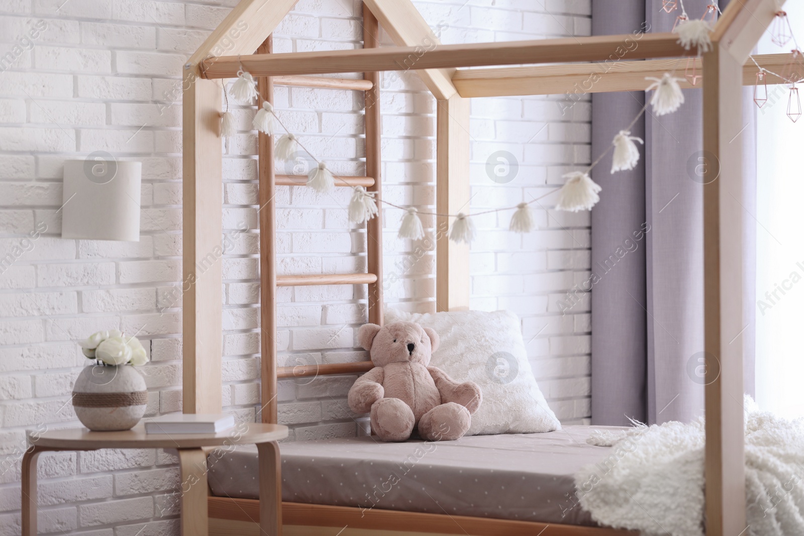 Photo of Stylish child room interior with cute wooden bed