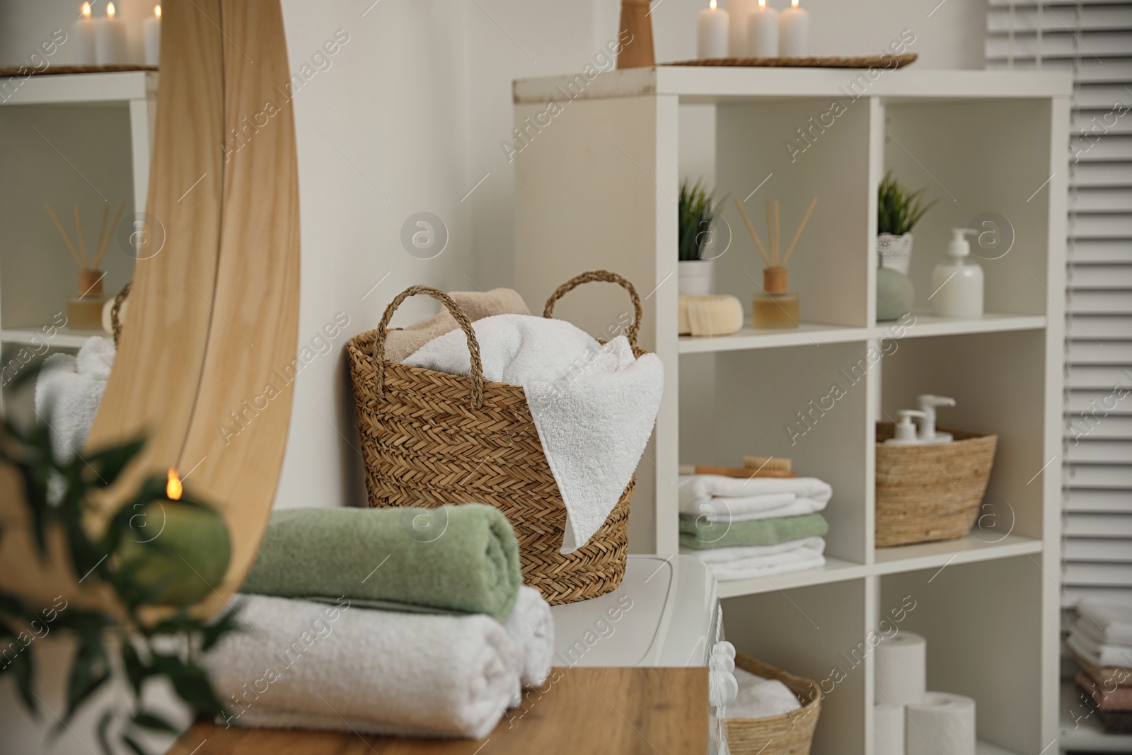 Photo of Fresh towels on wooden table in bathroom