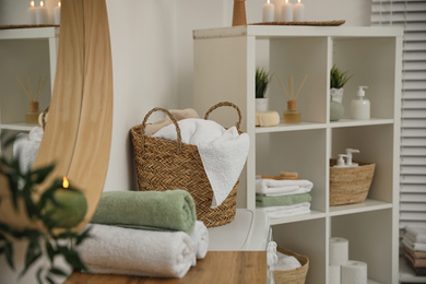 Fresh towels on wooden table in bathroom