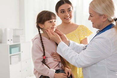 Mother with child visiting doctor in hospital