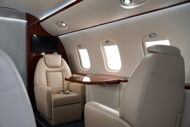 Image of Airplane cabin with comfortable seats and table