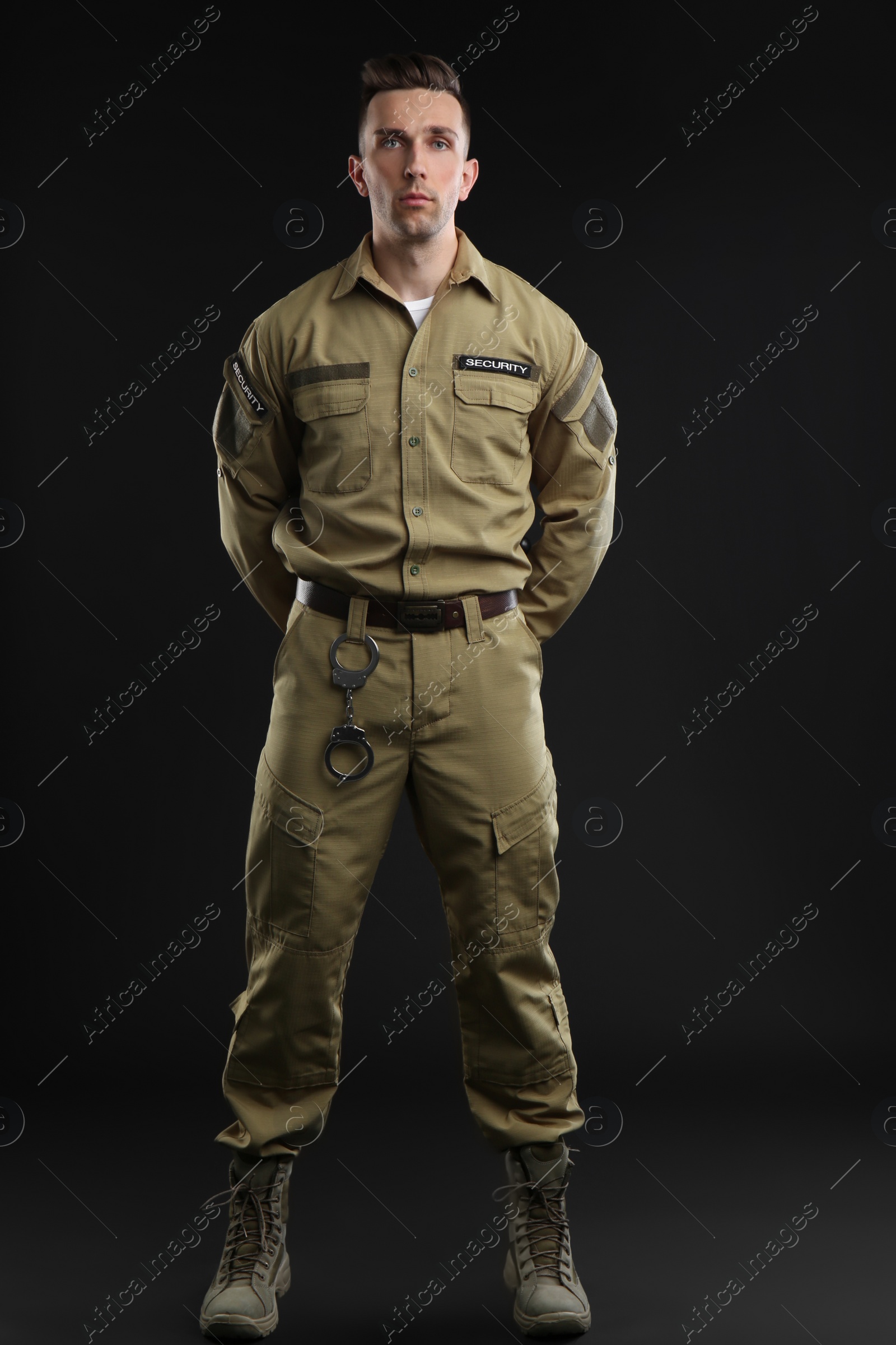 Photo of Male security guard in uniform on dark background