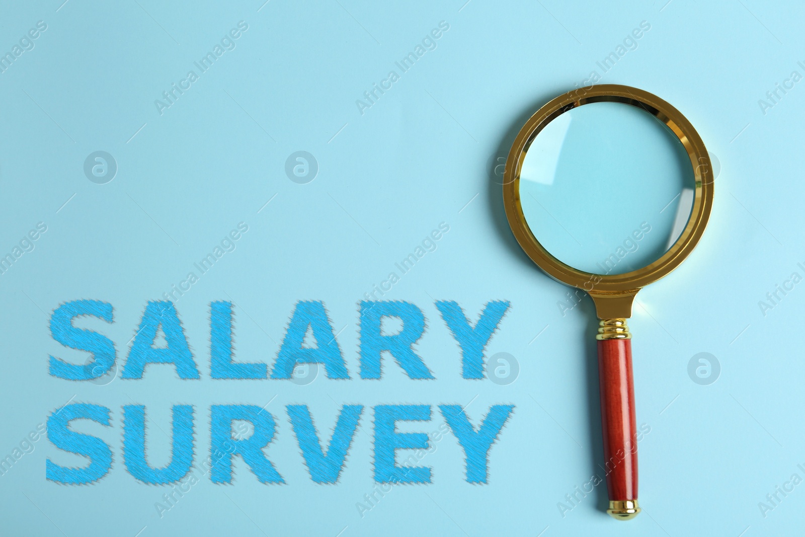 Image of Phrase Salary Survey and magnifying glass on light blue background, top view