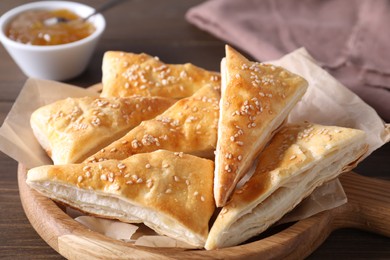 Delicious puff pastry on wooden table, closeup