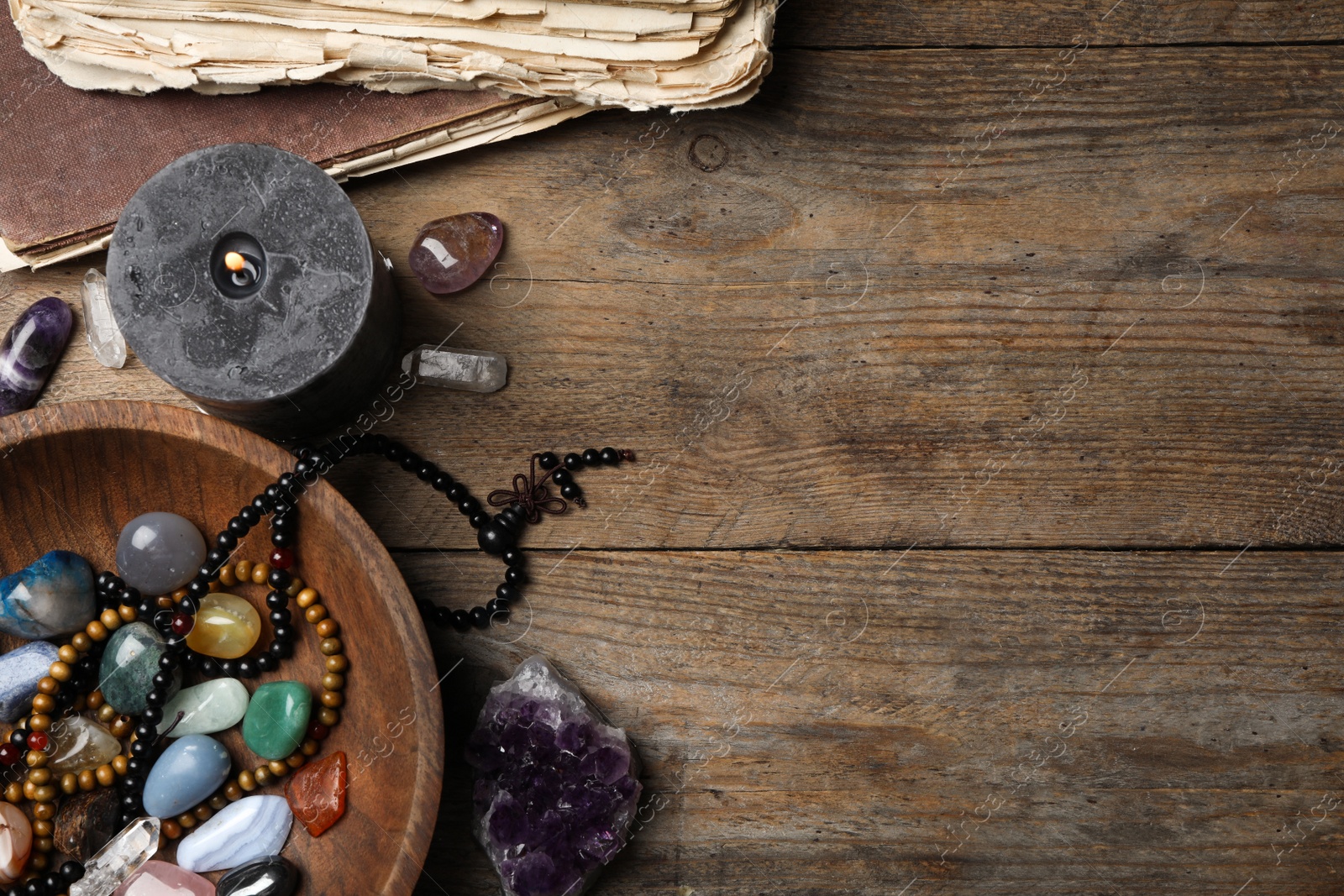 Photo of Flat lay composition with different gemstones on wooden background. Space for text