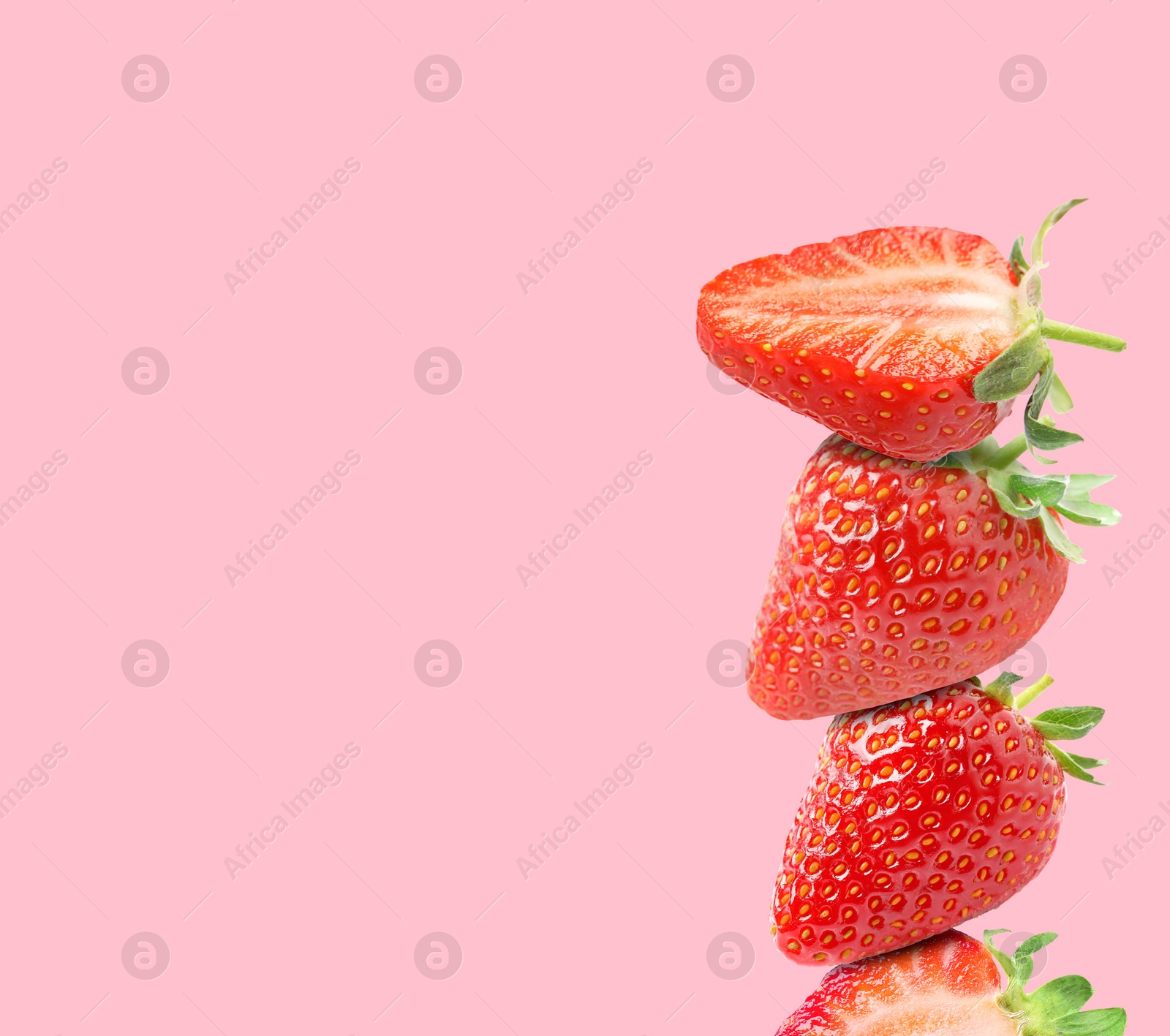 Image of Stack of fresh strawberries on pink background, space for text