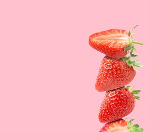 Image of Stack of fresh strawberries on pink background, space for text