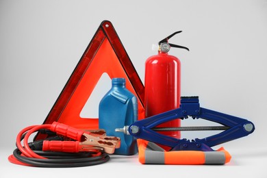 Photo of Set of car safety equipment on light grey background