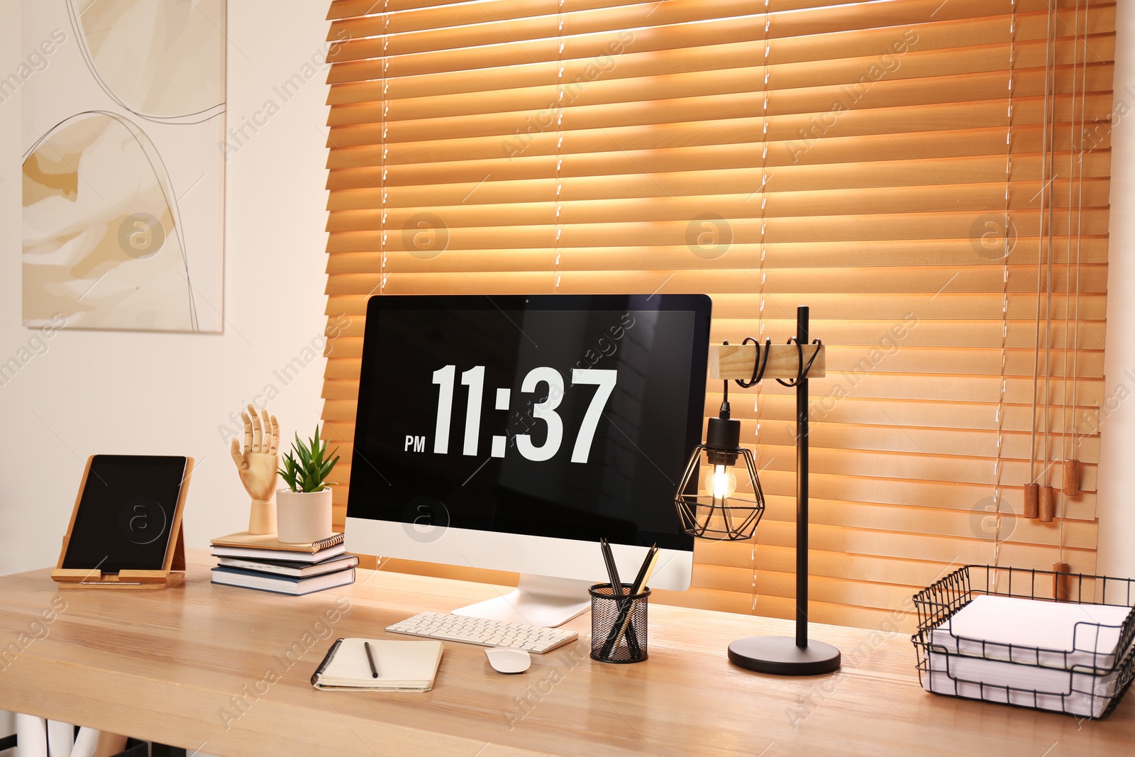 Photo of Modern computer on wooden desk near window. Interior design