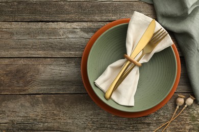 Photo of Stylish setting with cutlery, bowl and plate on wooden table, top view. Space for text