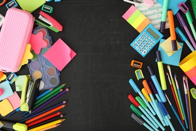 Photo of Different stationery on blackboard, flat lay with space for text. Back to school