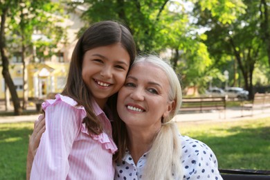 Mature woman with her little granddaughter in park