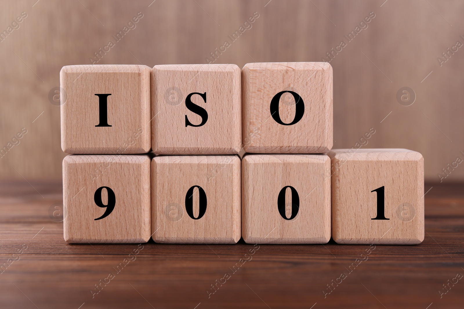 Photo of Cubes with abbreviation ISO and number 9001 on wooden table