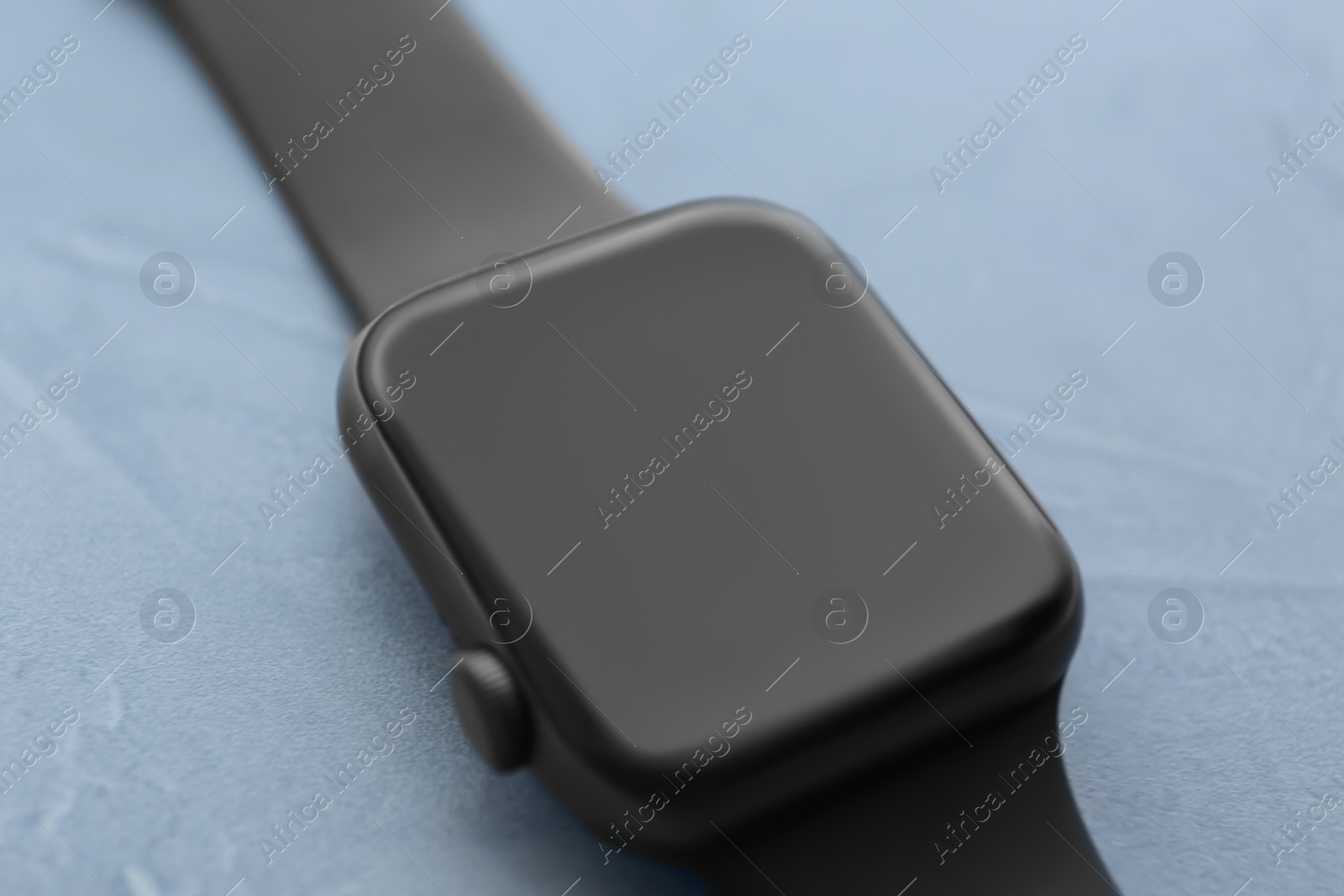 Stylish smart watch on grey stone table, closeup Photo of Stylish smart watch on grey stone table, closeup